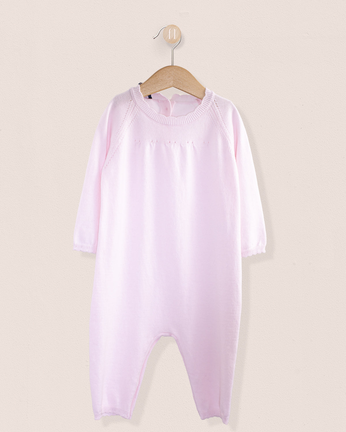 Front view of the Anastasia Baby Pink Cotton Knit Romper, a finely knit one-piece with long sleeves and soft ribbed collar, cuffs, and hems, made from pale pink Italian cotton.