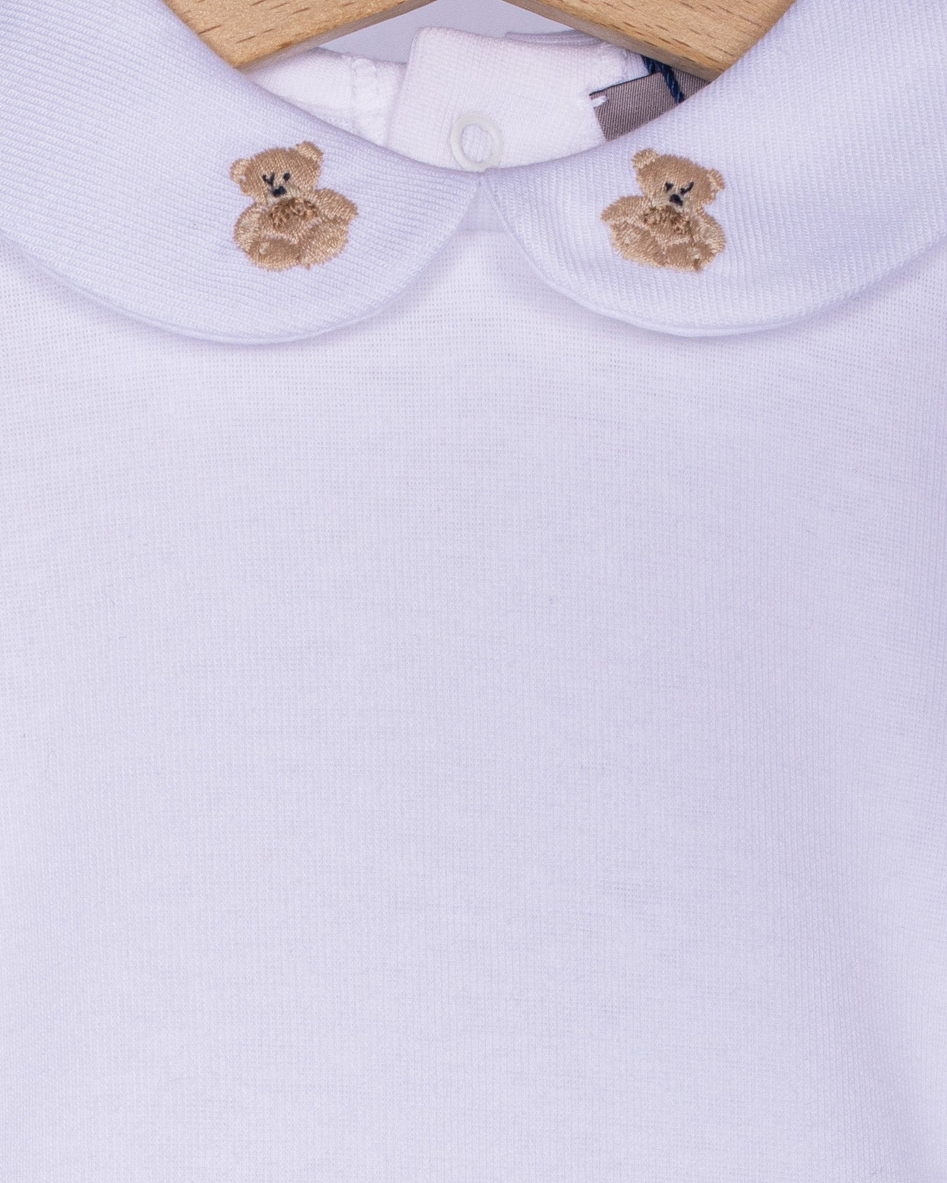 Close-up detail of the beige scalloped collar on a white cotton baby onesie, showcasing two hand-embroidered beige teddy bears with delicate stitching.