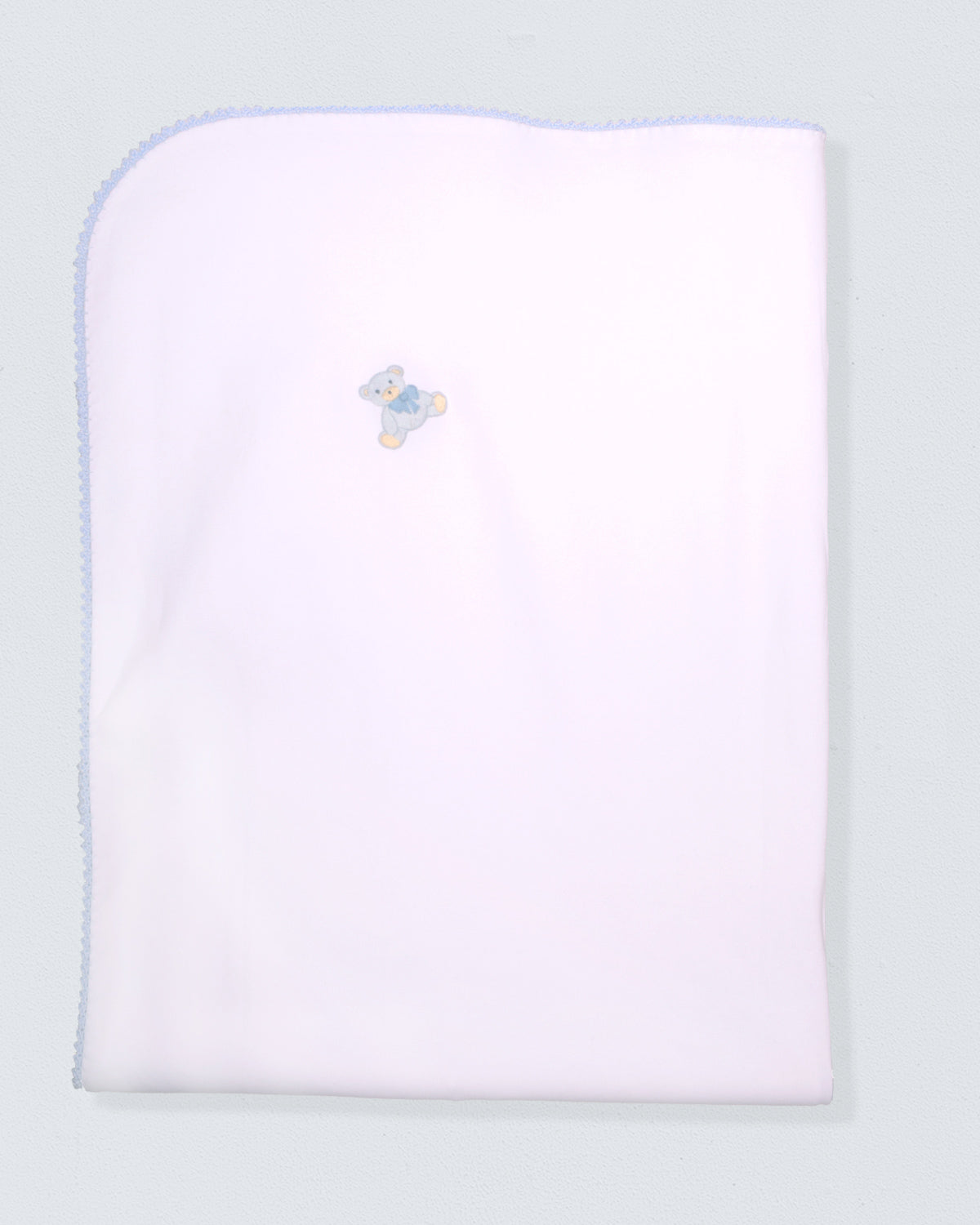 White baby blanket with a blue trim and embroidered design on a light gray background