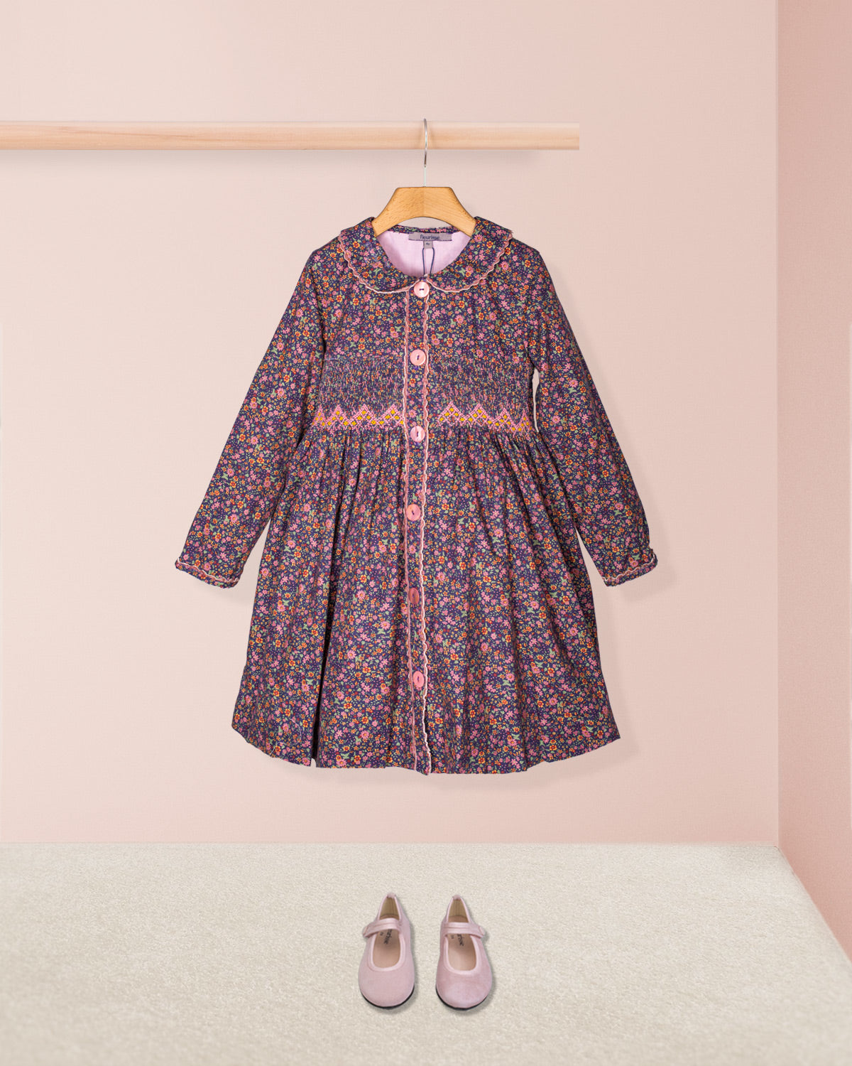 Floral dress with pink shoes on a light pink background