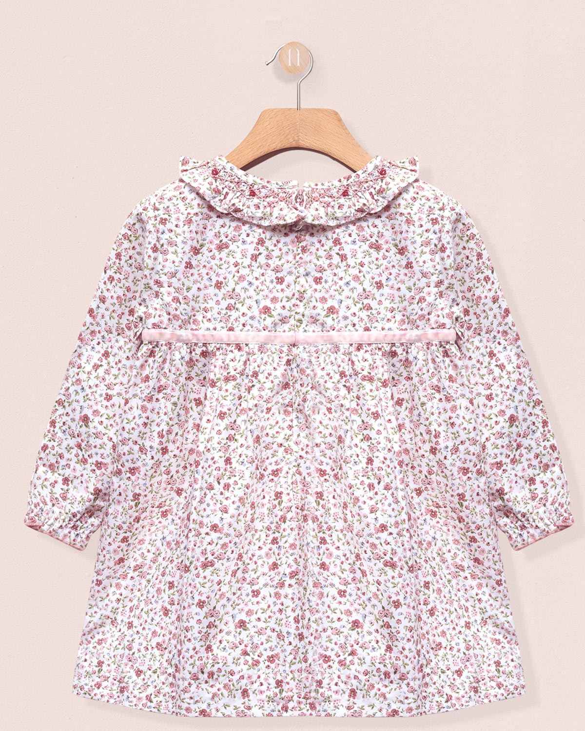 Floral patterned dress on a beige background back view