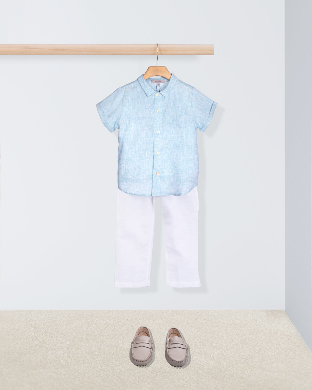 aqua shirt, white pants, and gray loafers on a white background
