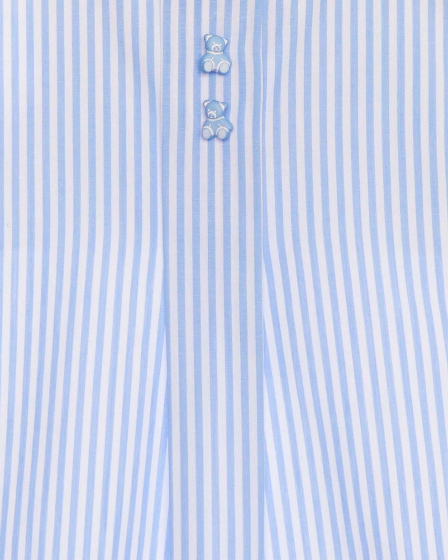 Close-up of a light blue and white striped shirt with teddy bear buttons.