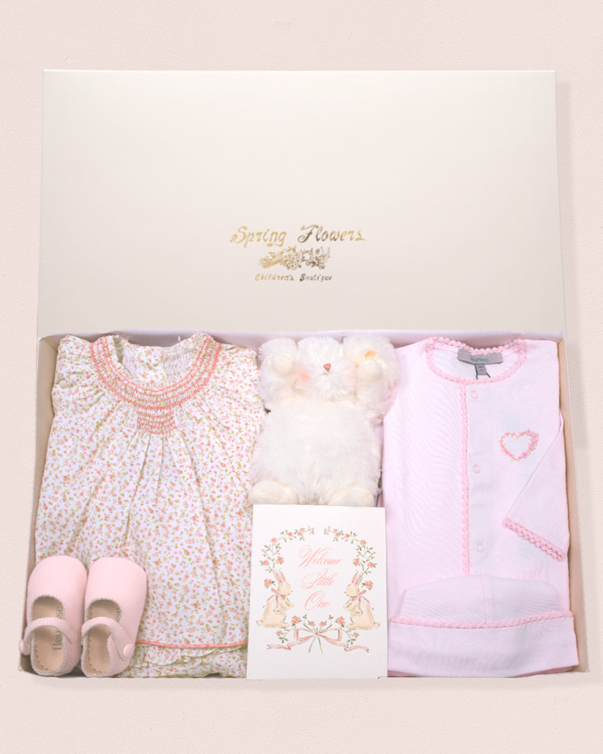 Baby clothing set with dress, shoes, and fottie set in a gift box.
