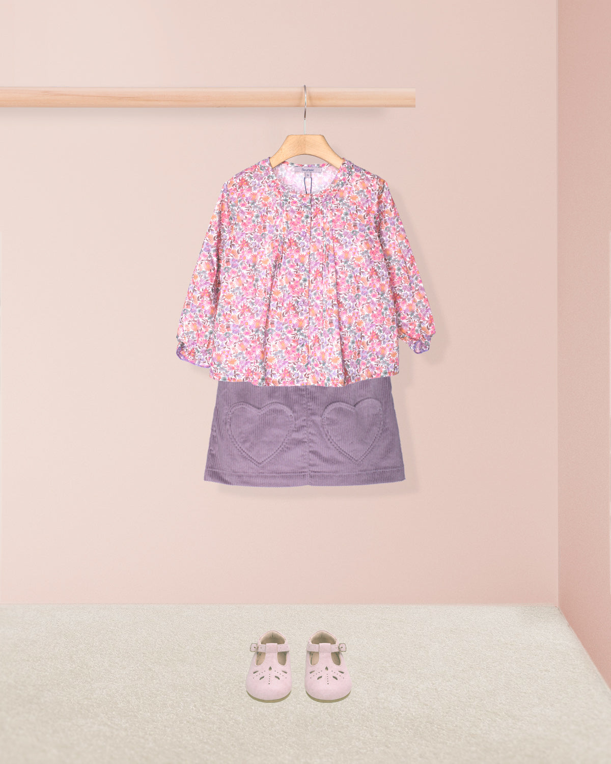 tunic and skirt outfit in dressing room with pink shoes