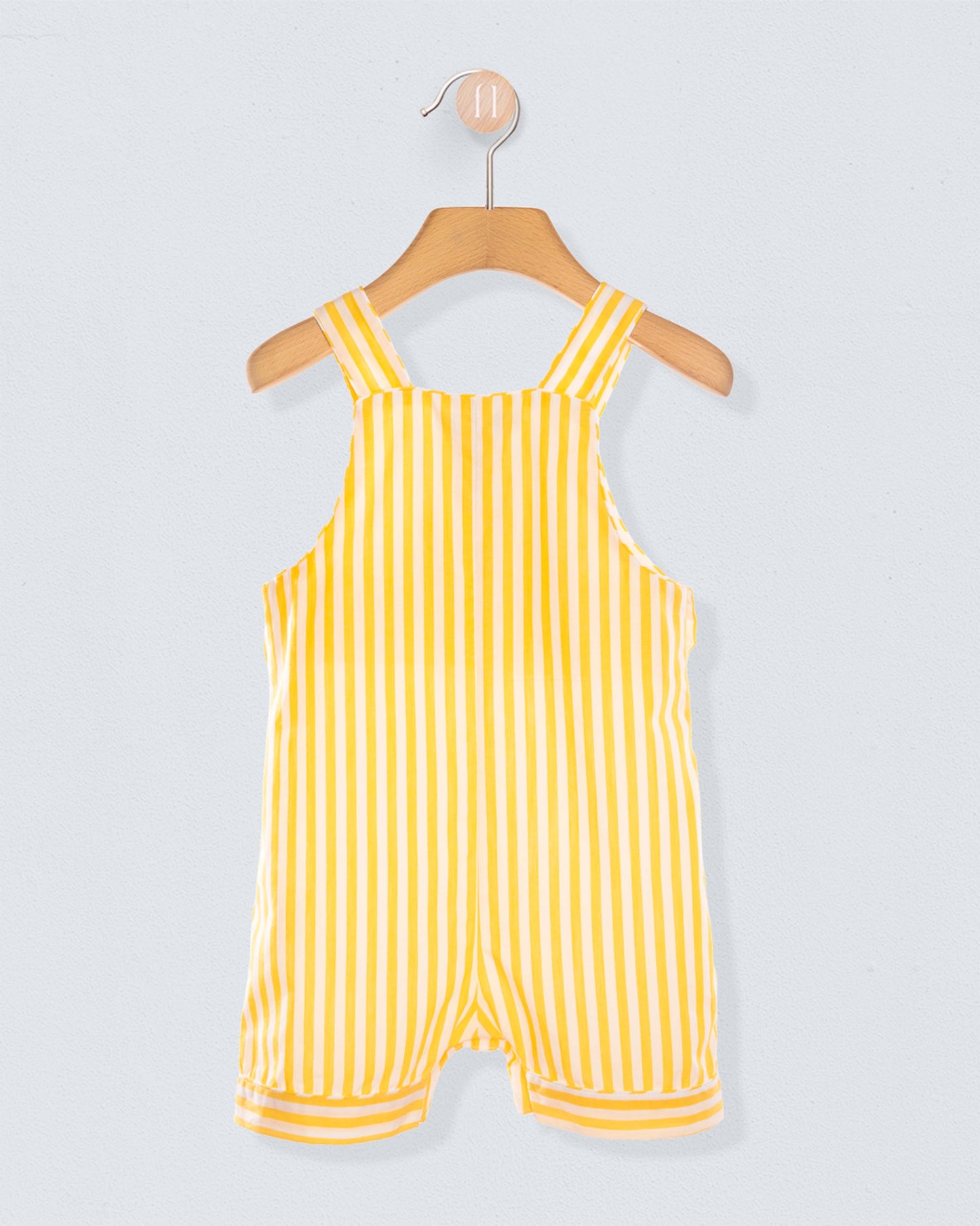 Back of Yellow striped shortall on a hanger against a light gray background