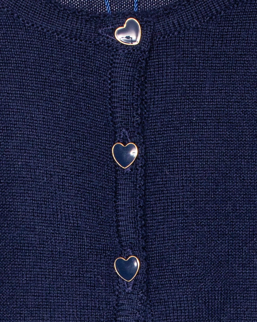 Close-up of a navy blue fabric with heart-shaped buttons.