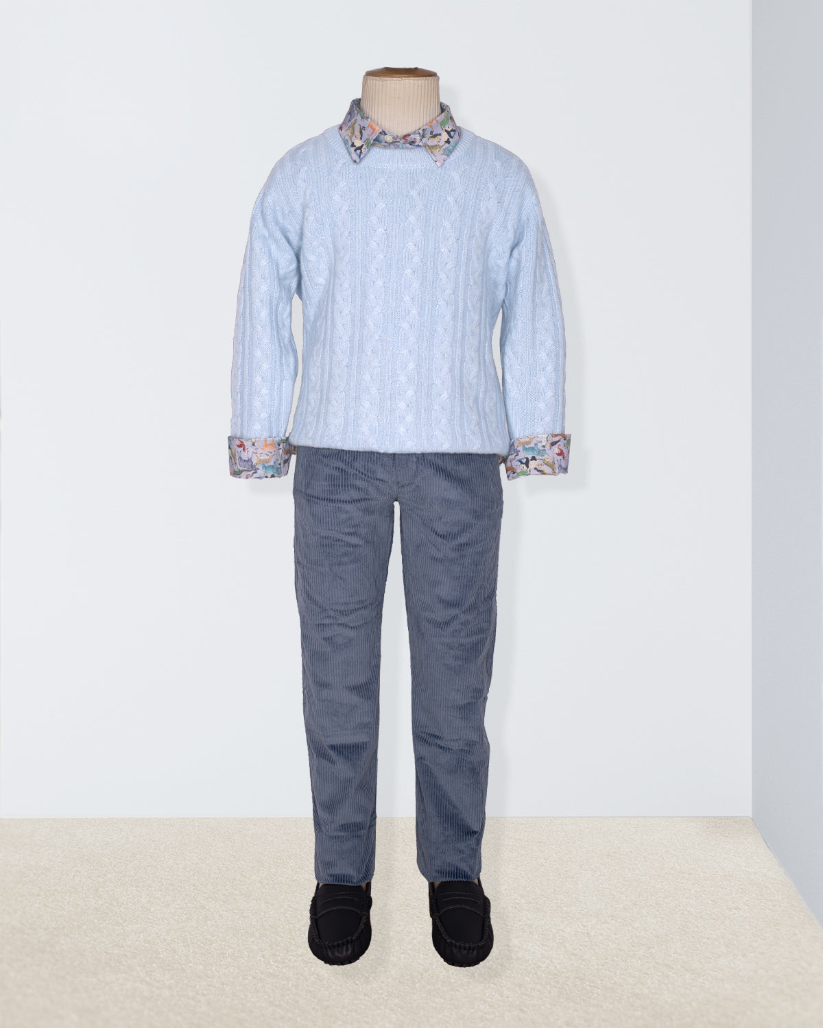 Mannequin wearing a light blue shirt with patterned collar and cuffs, paired with gray pants on a white background.
