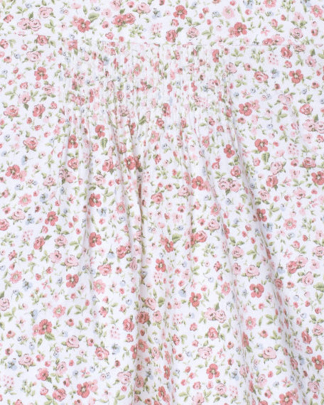 Floral patterned fabric with small pink flowers on a white background