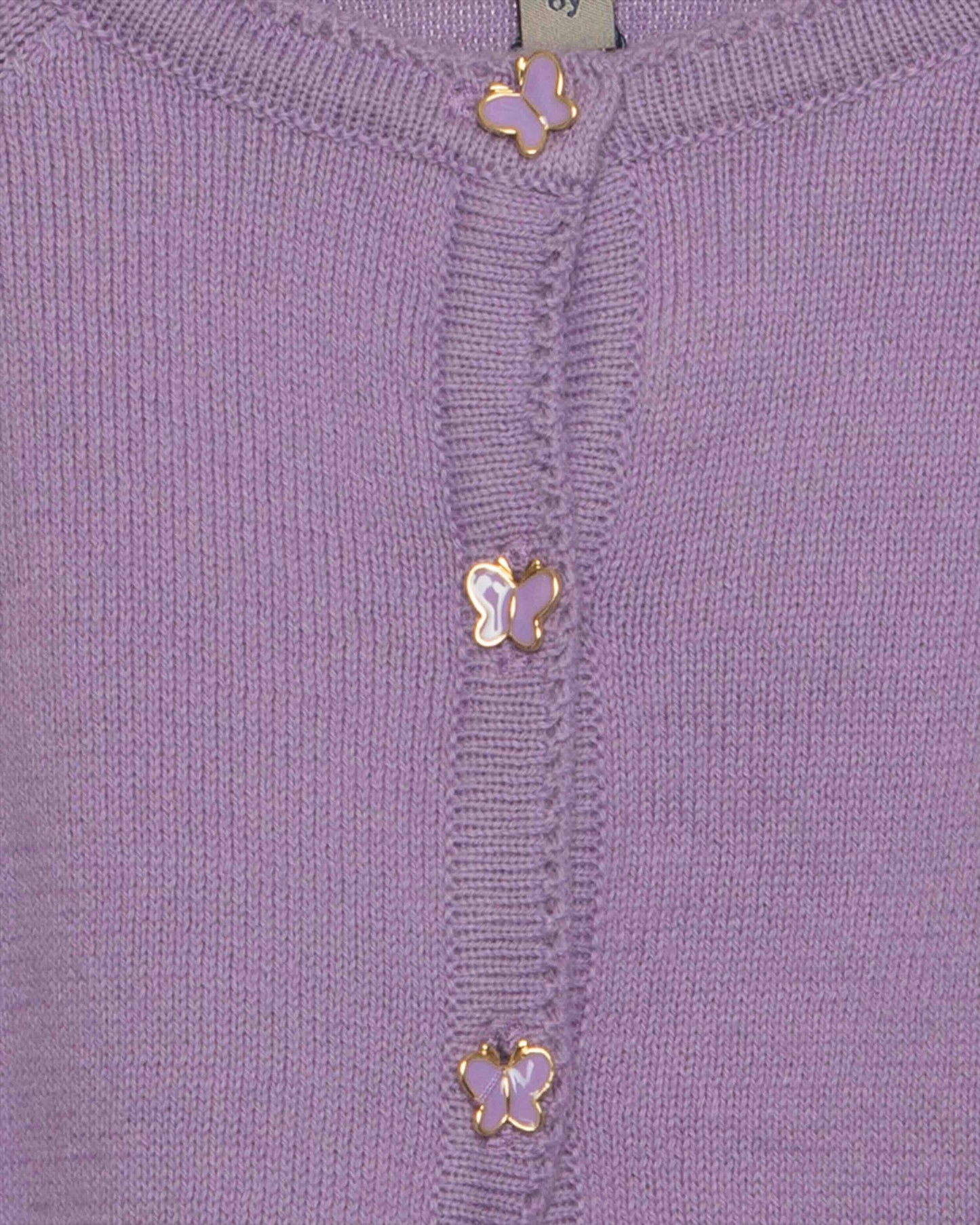 Close-up of a purple garment with gold butterfly embellishments.