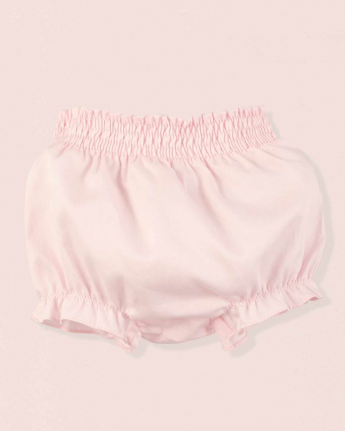 Pink baby bloomers on a light pink background