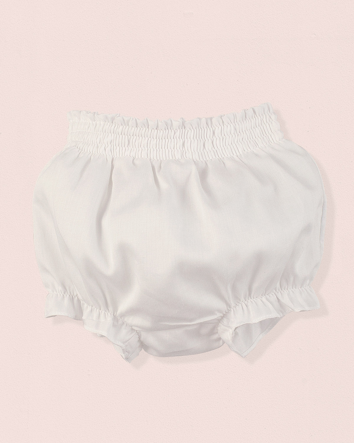 White baby bloomers on a pink background