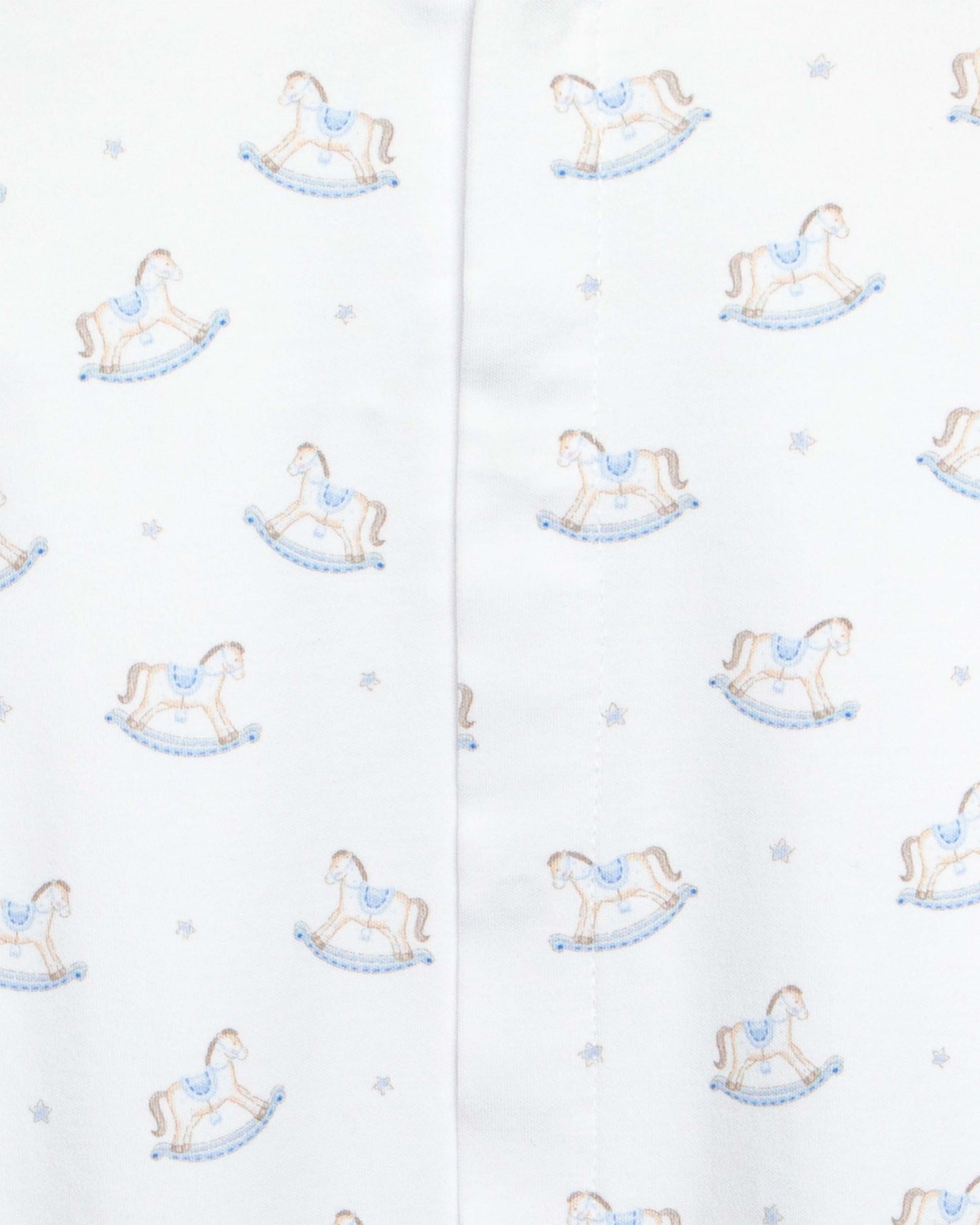 close up of white stretchie with blue and brown rocking horse designs