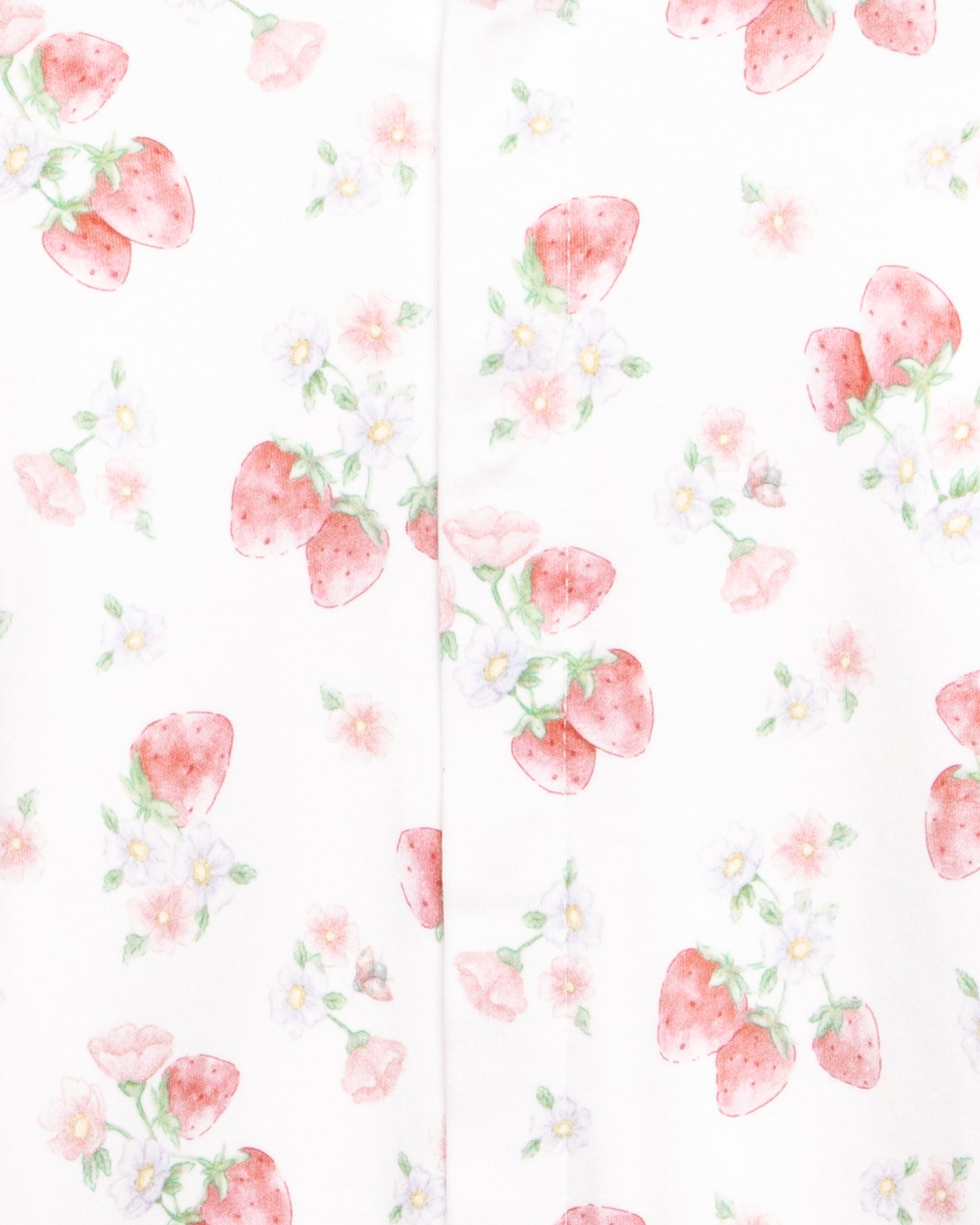 Close up of a white onesie with floral pattern with strawberries