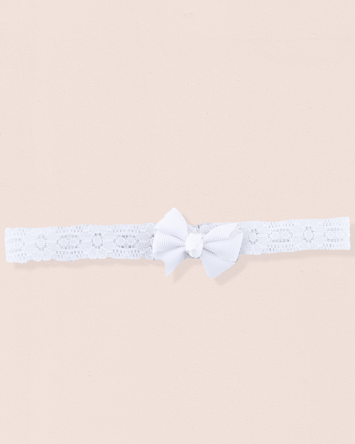 White baby headband made of lace with a centered grosgrain bow displayed on a neutral background
