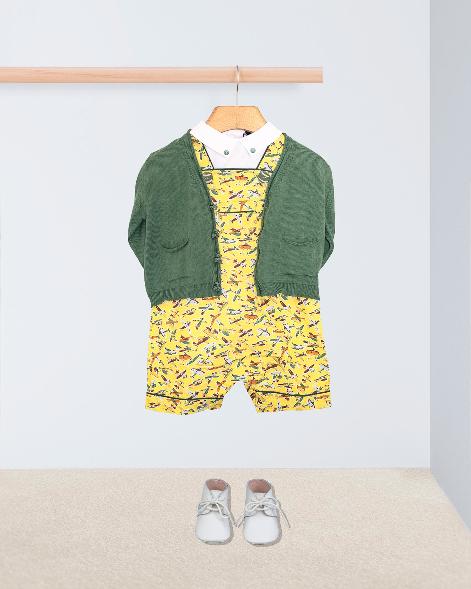 Starboard Liberty Adventure Yellow Shortall paired with a onesie t-shirt and a sweater on a hanger