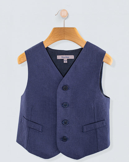 Front view of navy linen vest with three corozo buttons and two front pockets, hanging on a wooden hanger
