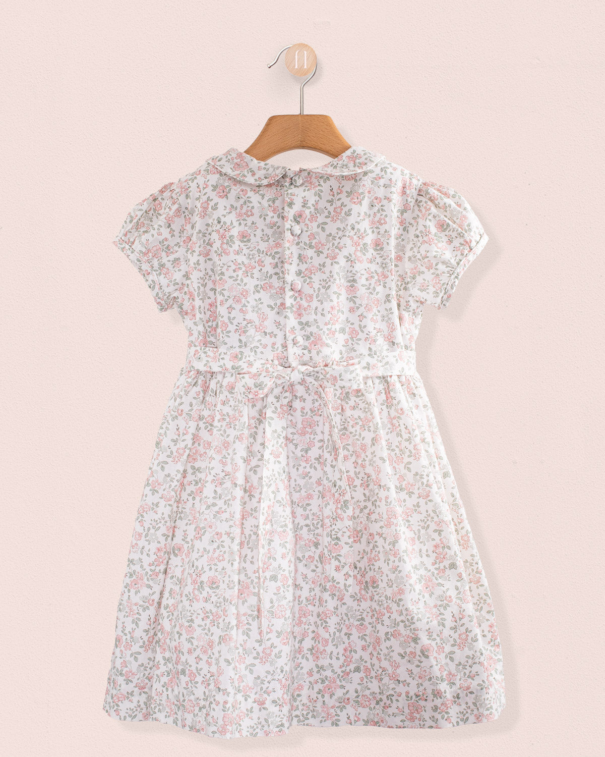 Back view of Amanda Blush Garden Smocked Dress showing button closure and sash ties