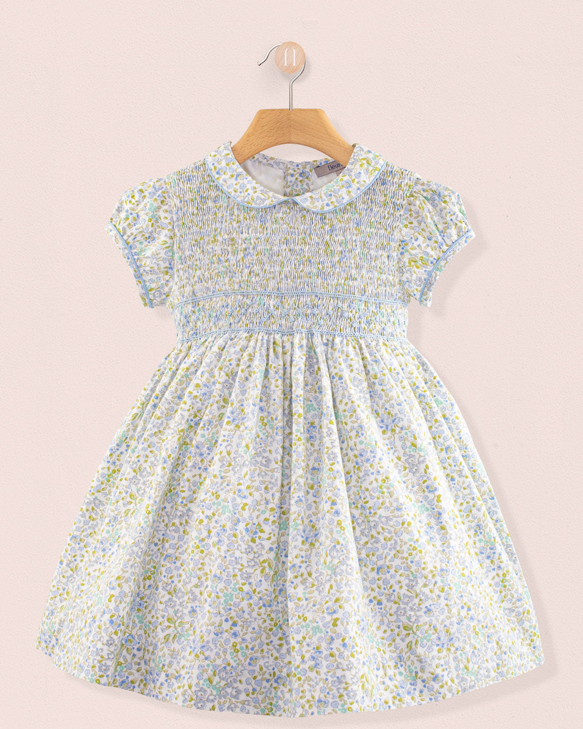 Front view of Amanda Lauren Blue Floral Smocked Dress on hanger