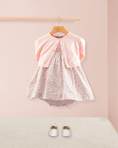 Baby Amelie Garden Pink Set layered with a petal pink cardigan and bloomers paired with pink Mary Jane shoes