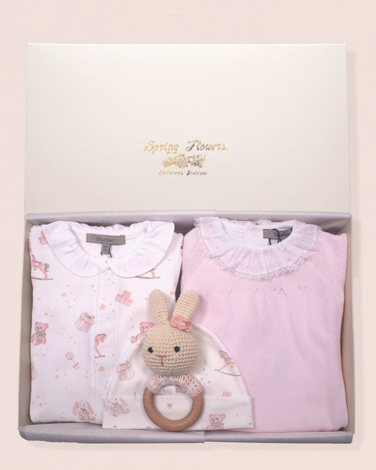 Baby clothing set with pink and white shirts and a toy in a box
