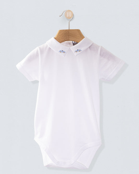 White baby onesie made from fine Italian cotton, displayed on a wooden hanger, with a collar embroidered with light blue car motifs on both sides.