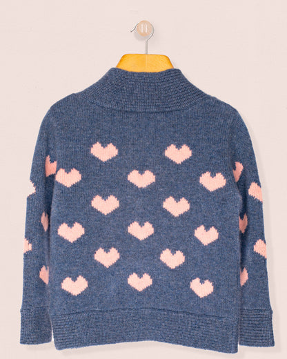 Back of Blue sweater with pink heart patterns on a beige background