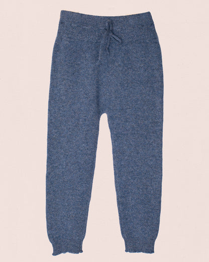 Blue knitted pants on a beige background