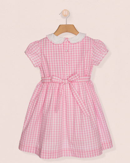 Back of Pink checkered dress with white collar on a beige background