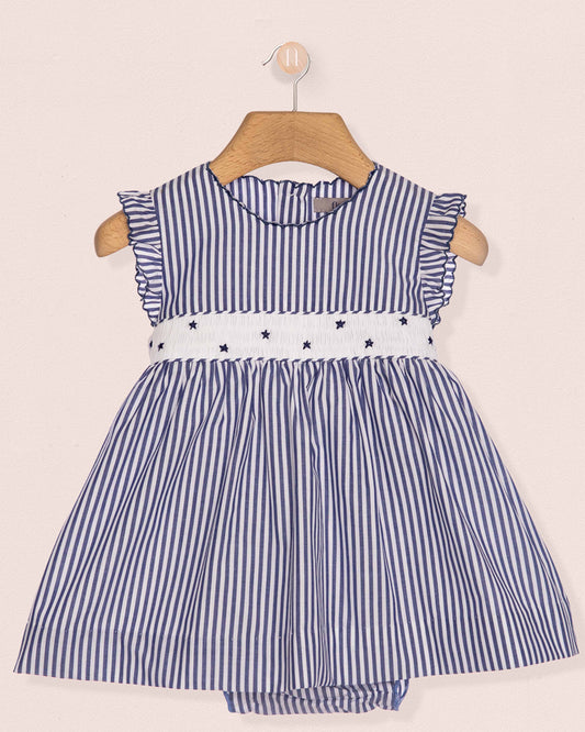 Blue and white striped dress with star details on a beige background