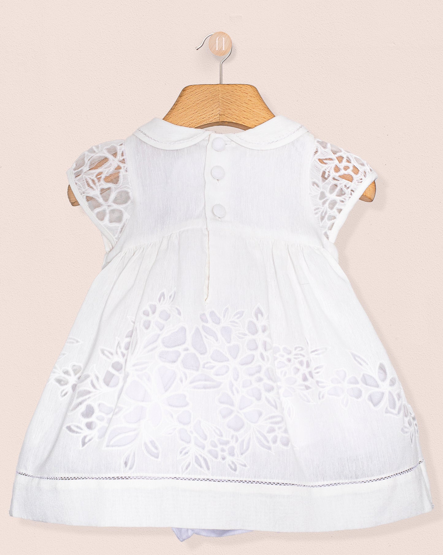 Back view of the Baby Emmy Doppia White Smock Dress Set, showing back buttons and matching diaper cover.