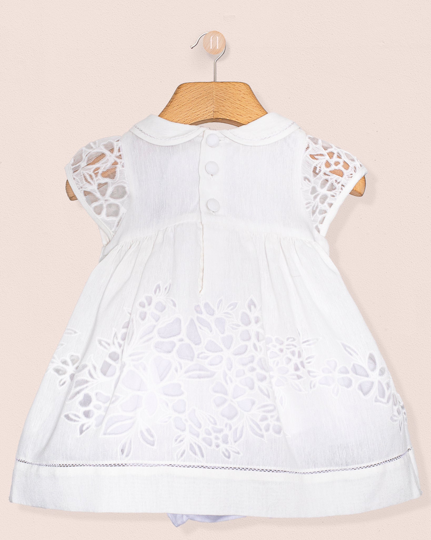Back view of the Baby Emmy Doppia White Smock Dress Set, showing back buttons and matching diaper cover.