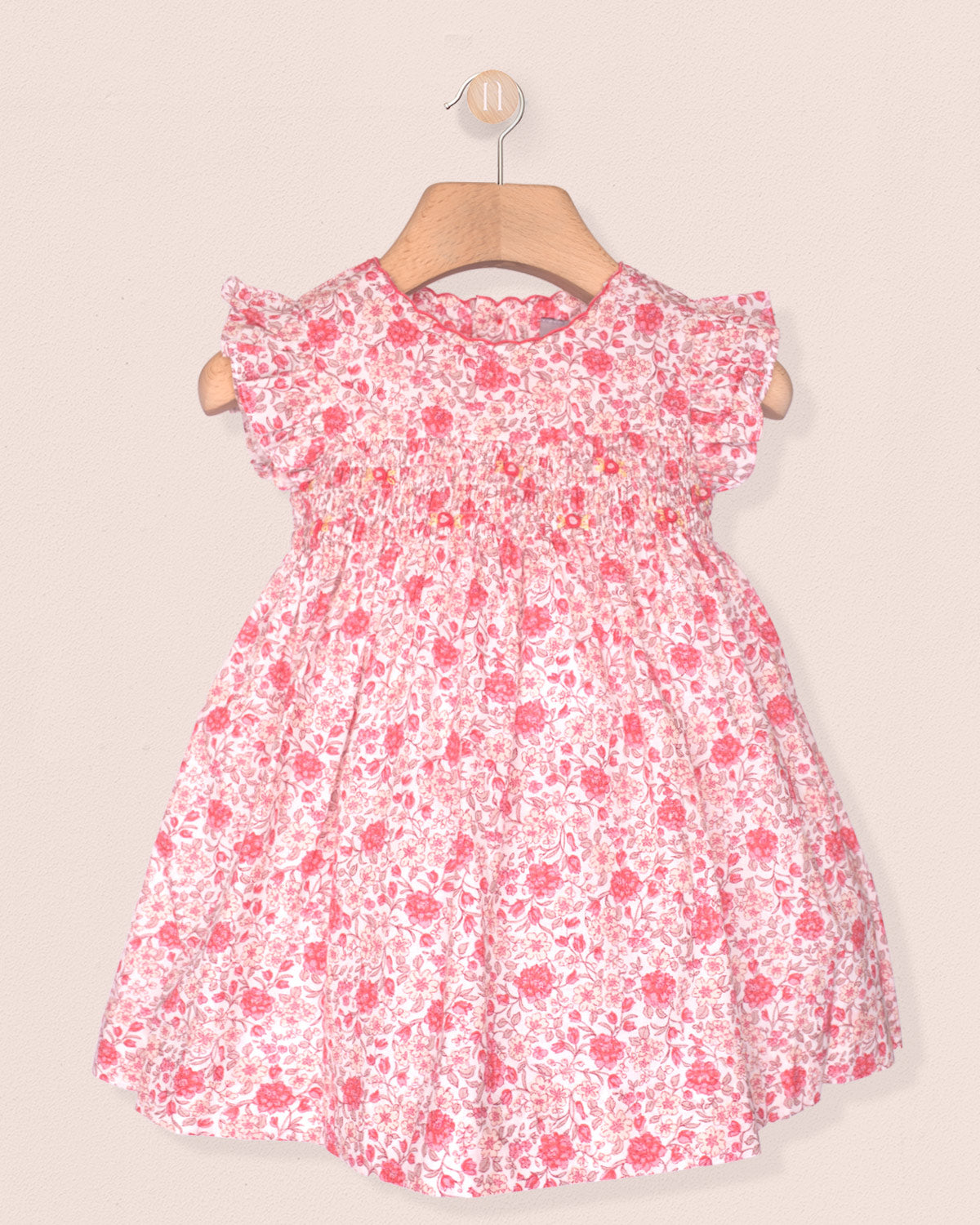 Pink floral dress on a beige background