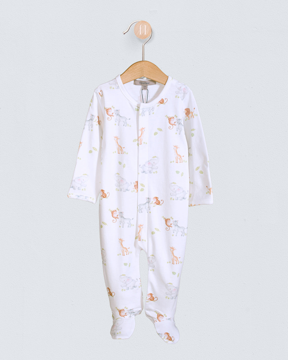 Baby onesie with animal pattern on a hanger against a white background