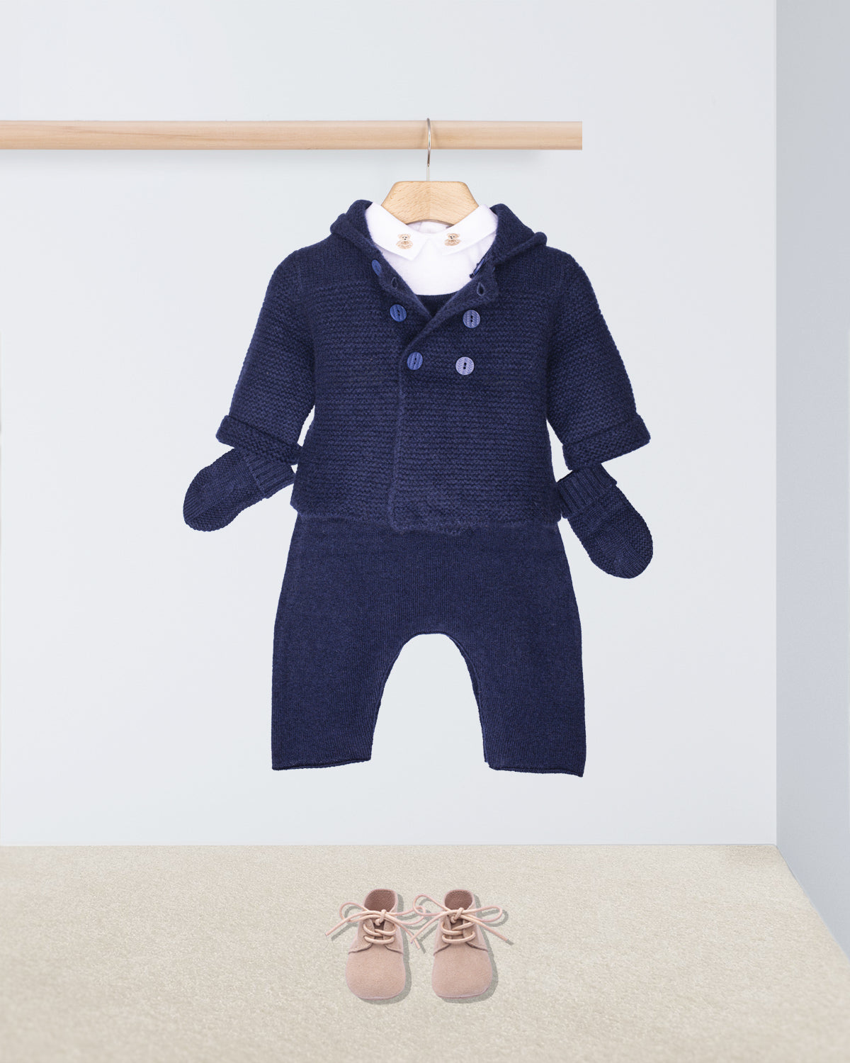 Navy blue baby outfit with matching hat, mittens, and shoes on a white background.