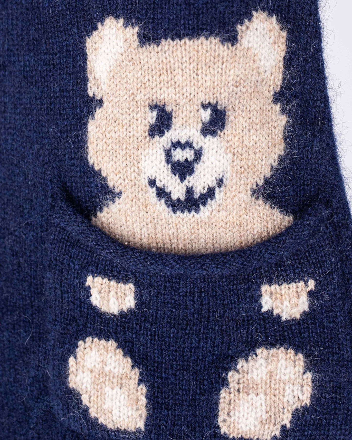 Navy blue sock with a beige bear face design