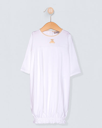 White baby outfit on a hanger against a light gray background