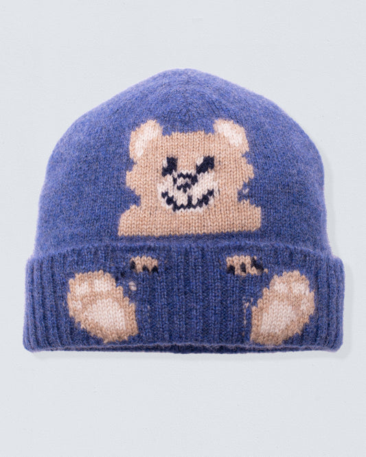 Blue knit beanie with bear design on a light gray background