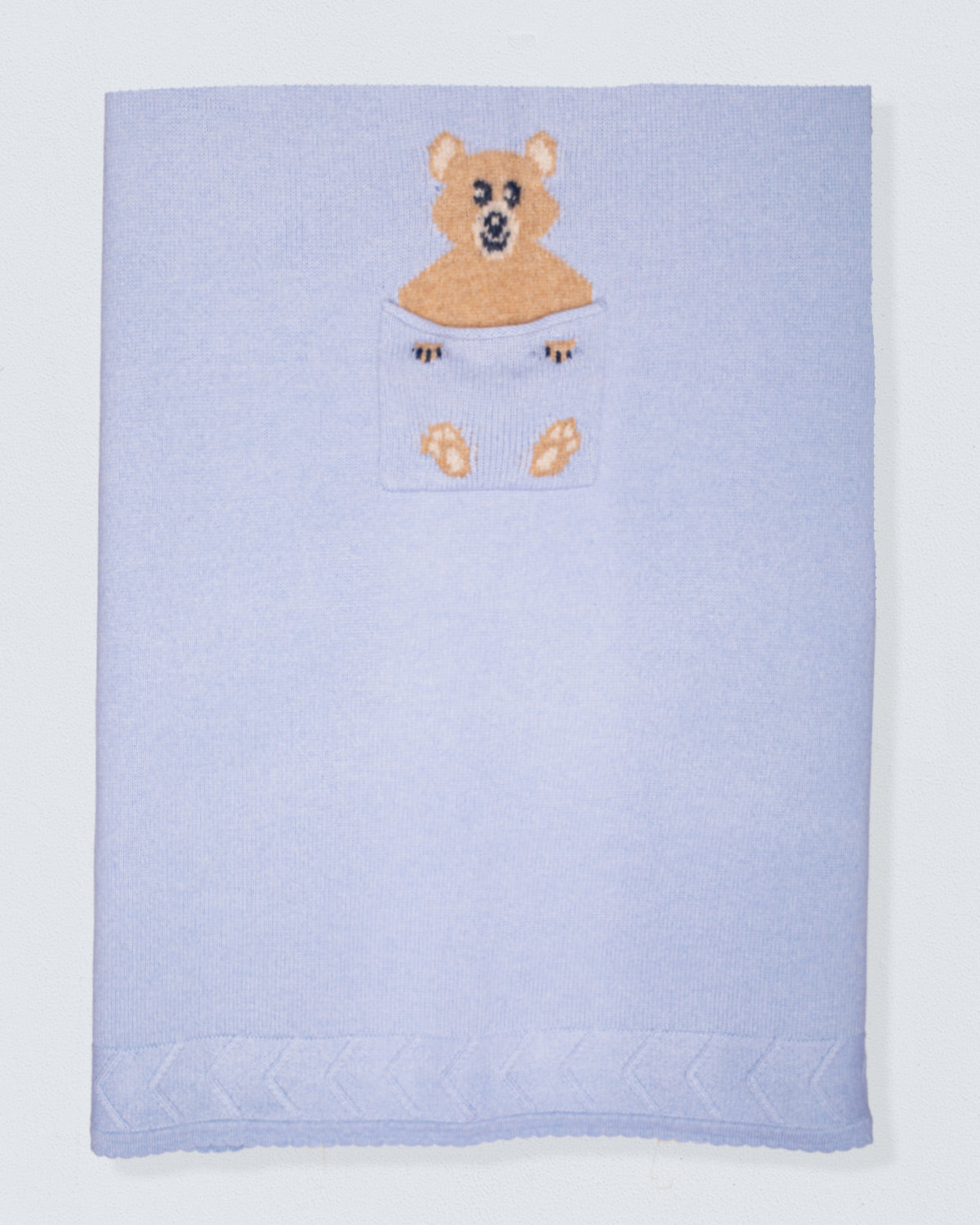 Light blue cashmere blanket with a teddy bear design on a white background