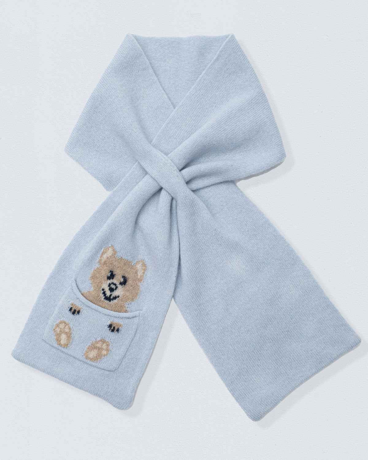 Light blue scarf with a teddy bear pocket on a light gray background