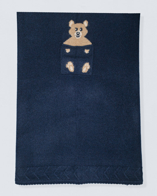 Navy blue cashmere blanket with a bear design in the center on a white background