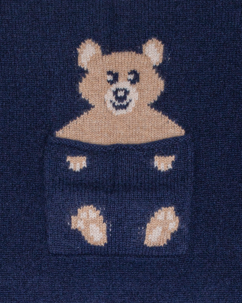 Close-up of a navy blue sweater with a teddy bear design.