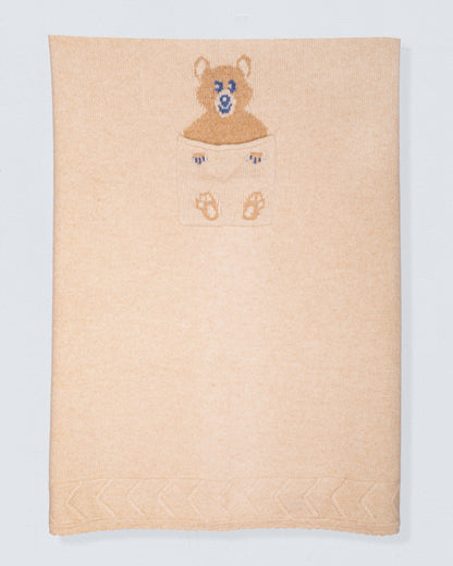 Beige cashmere blanket with embroidered bear design on a white background