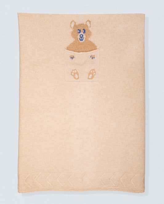 Beige cashmere blanket with embroidered bear design on a white background
