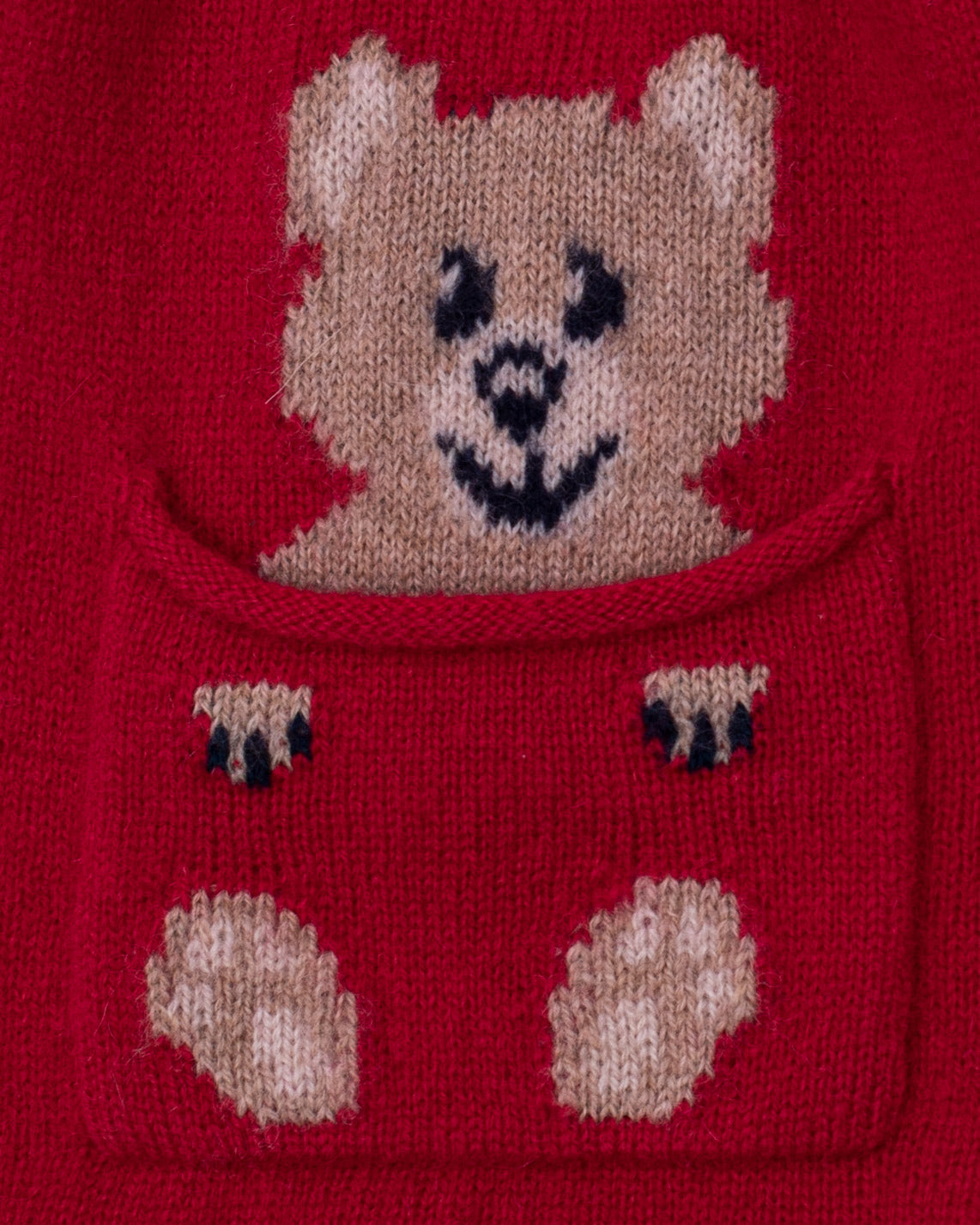 Close up of a red cashmere scarf with a knitted bear face and paw prints on pocket