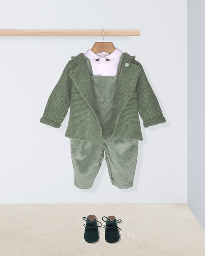 Green baby outfit with jacket, pants, and shoes on a white background