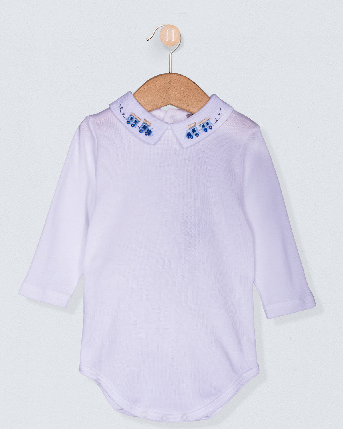 white shirt with train collar on a wooden hanger against a light gray background