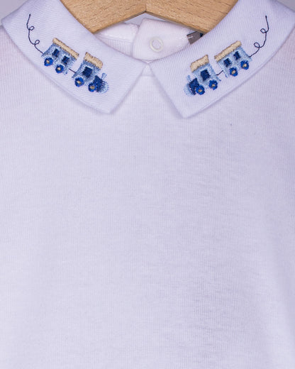 close-up White shirt collar with train embroidered blue designs on a white background