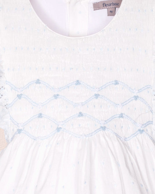 White dress with blue embroidery and 'fleurisse' brand label.