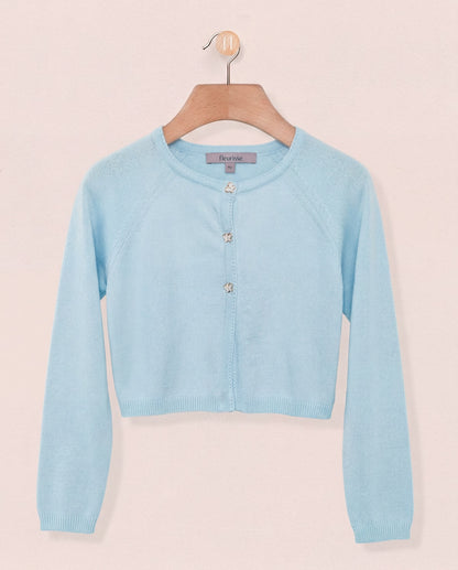 Light blue cardigan on a hanger against a light pink background